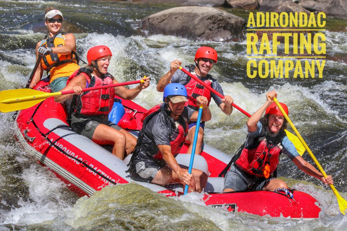 Rafters paddling whitewater with ARC logo