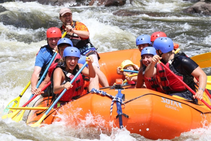 Rafters paddling whitewater